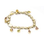 A yellow metal charm bracelet, each charm set with coloured gemstone, some marked 18K, 19cm, 21g