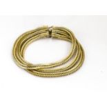 A yellow metal three chain bracelet, marked 750 P*G, the continental bracelet with three herringbone