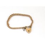 A 9ct gold curb linked and padlock clasped bracelet, 21g
