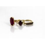 Two 9ct gold garnet dress rings, ring sizes Q and O, together with a continental yellow metal red