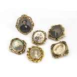 A collection of ambrotype and painted photograph framed brooches, all Victorian with gilt metal