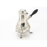 An Edwardian silver café au lait pot from Charles Stuart Harris, London 1902, with embossed rococo