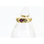 A Victorian 18ct gold diamond and ruby three stone ring, centred with oval ruby and two old cut