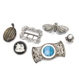 A Victorian silver oval locket, a Victorian pierced and shaped silver belt buckle, a George V silver