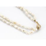 A continental two row freshwater pearl and gold and diamond necklace, the two row necklace