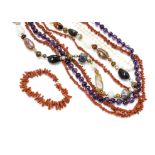 A knotted string of uniform amethyst beads, two coral necklaces, a bracelet example, mother of pearl