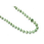 A graduated string of jadeite Jade knotted beads, light green, largest 10.5mm diameter, smallest 4.