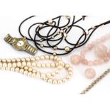 A quantity of costume and silver jewels, including rose quartz beads, a silver globe Tibetan bell,