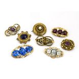 A collection of eight Victorian and later gem set gilt metal brooches, including simulated amethyst,
