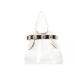 An 18ct white gold half hoop ruby and diamond eternity ring, the modern, brilliant diamonds