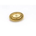 A Victorian 15ct gold oval brooch, the three stepped mounts with fine filigree decoration having