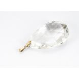 A large rock crystal and gold mounted pendant, the tear shaped cut rock crystal with yellow metal