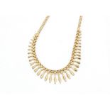 A 9ct gold Cleopatra style fringe necklace, with stylised Greek Key design and double oval link