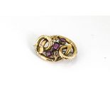 A Victorian garnet mounted knot brooch, the three step cut garnets in claw, closed settings within a