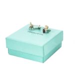A pair of modern silver cufflinks from Tiffany & Co, with propellers, in box and bag