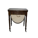A Regency rosewood and rosewood veneered work table, the oblong top with rounded corners and an