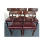 A set of five mahogany dining chairs, upholstered with studded burgundy leather seats, AF