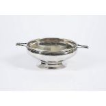 An Arts and Crafts style silver plated bowl, hammered structure with twin handles, unmarked,