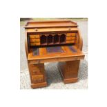 A late 19th Century pedestal roll top desk, having fitted interior, with burr maple drawer fronts,