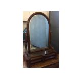 A William IV mahogany dressing table mirror, the arched swing mirror above a two drawer base, raised