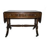 An English Regency mahogany and rosewood cross banded sofa table, the oblong flat top with rounded