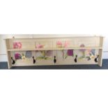 A Mid 20th Century wall mounted oak coat rack, painted with four floral decorated panels and five