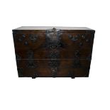 A 19th Century Chinese elm and metal bound travelling chest, the oblong top over a fall revealing