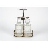 A silver plated two bottle tantalus, with two moulded glass decanters, height 32.5 cm