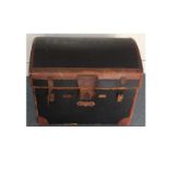 An Early 20th Century travelling trunk, domed structure with leather bindings, lined with an