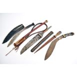 Two Middle Eastern Kukri knives, one having wooden handle with brass inlay, the other has the