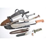 A collection of various knives and bayonets, including Brazilian machete, small kukris, toledo,