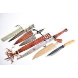 Four Overseas daggers and knives, including a double edged example with leather bound grip and