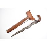 A 19th Century Malaysian Kriss dagger, having carved wooden pommel and scabbard