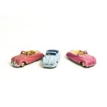 Dinky Toys 106 Austin Atlantic Convertible, three examples, first and second pink body, beige