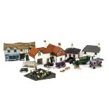 A 1/76 scale farm with accompanying vehicles comprising assembled plastic kit buildings (9), metal