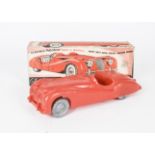 A large scale Tudor Rose Jaguar XK140, in red polythene with friction drive, in original box, length