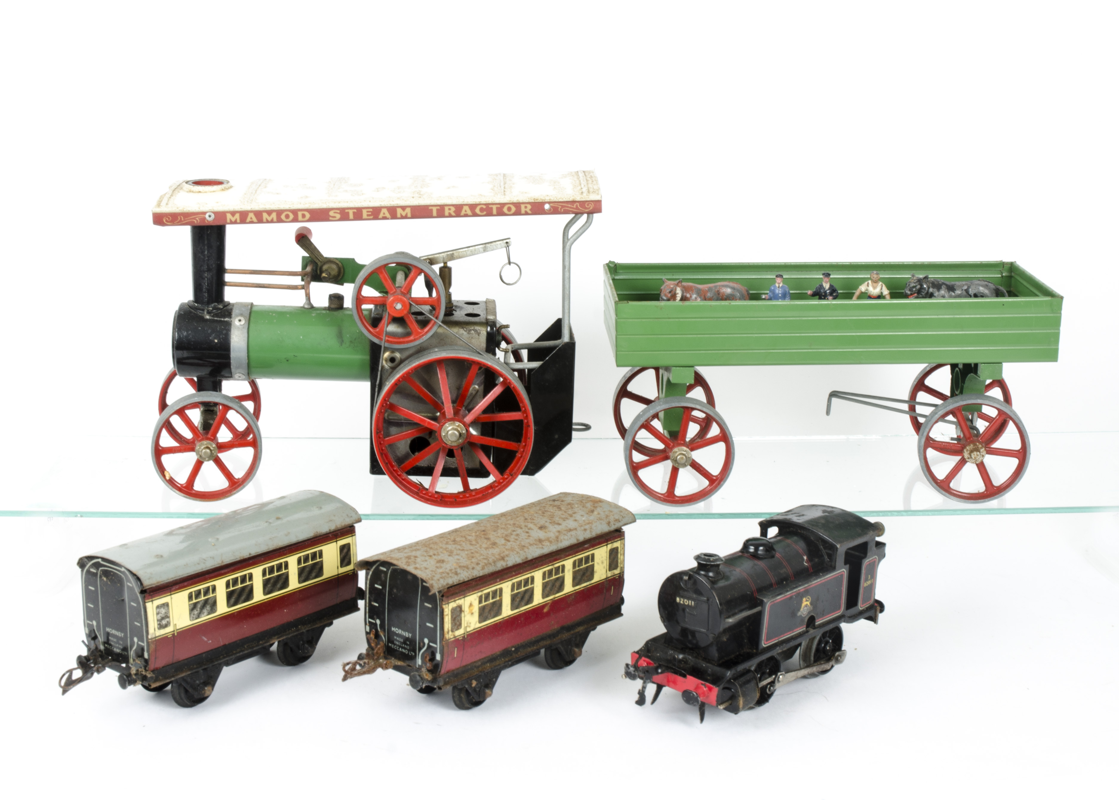 A Mamod TE1A Live Steam Traction Engine with a Hornby O Gauge Clockwork Train and Figures, The