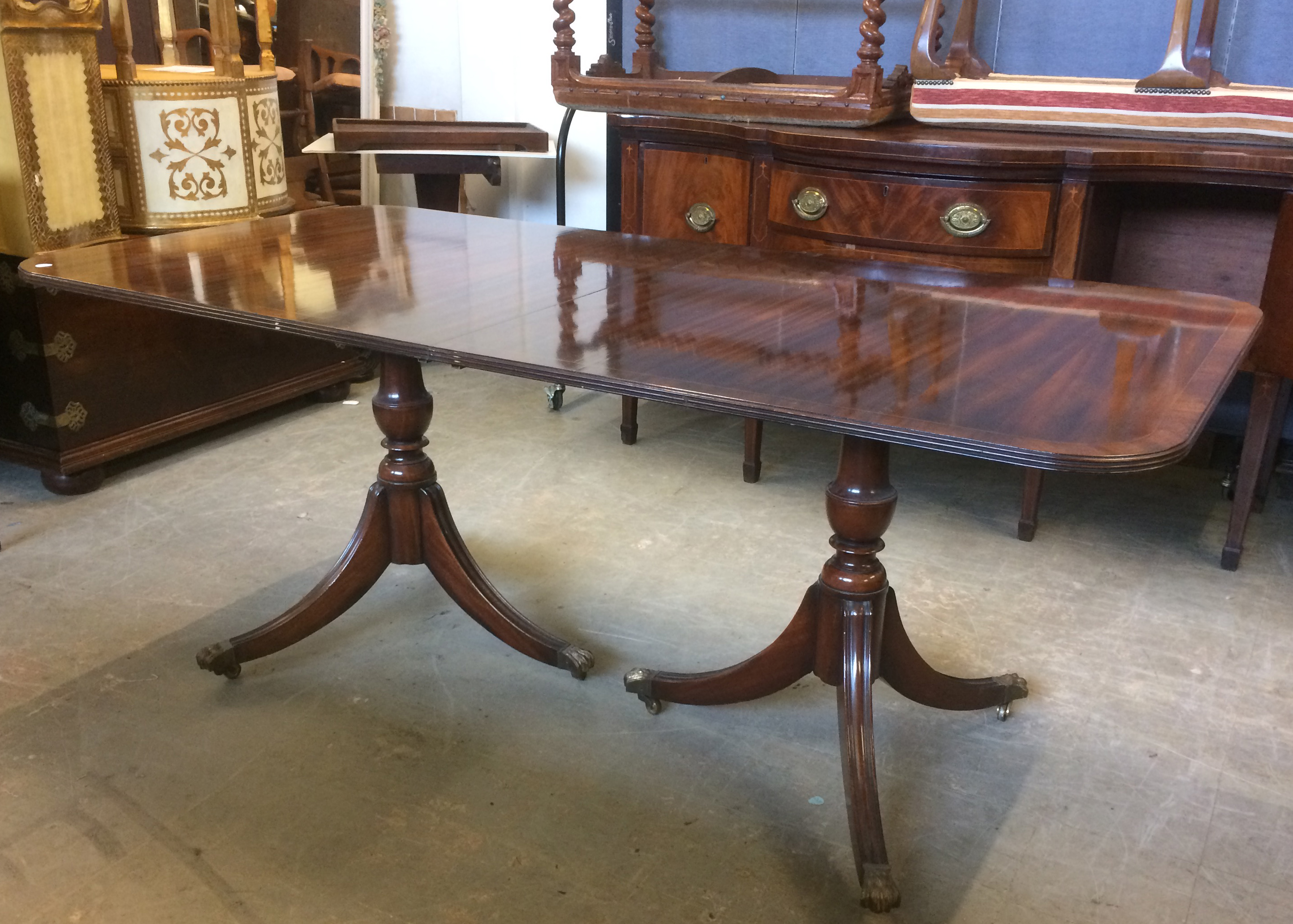 A Regency style mahogany twin pedestal dining table, with extra leaf, impressed 2761 to underside,