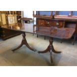 A Regency style mahogany twin pedestal dining table, with extra leaf, impressed 2761 to underside,