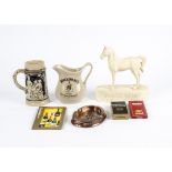 A collection of alcohol related memorabilia, including a J&B jug, a Belgium metal bottle opener in