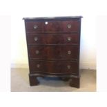 An early 20th Century Chippendale style mahogany serpentine front chest of drawers, with shaped