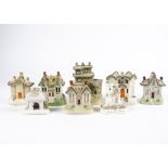 A small collection of Victorian and later Staffordshire pastille burner cottages, including one