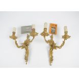 A pair of gilt metal two branch wall lights, of carved scrolling form, length 39cm, together with an