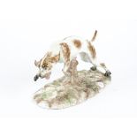 A continental porcelain figure of a leaping dog, likely late 19th or early 20th Century, a/f with
