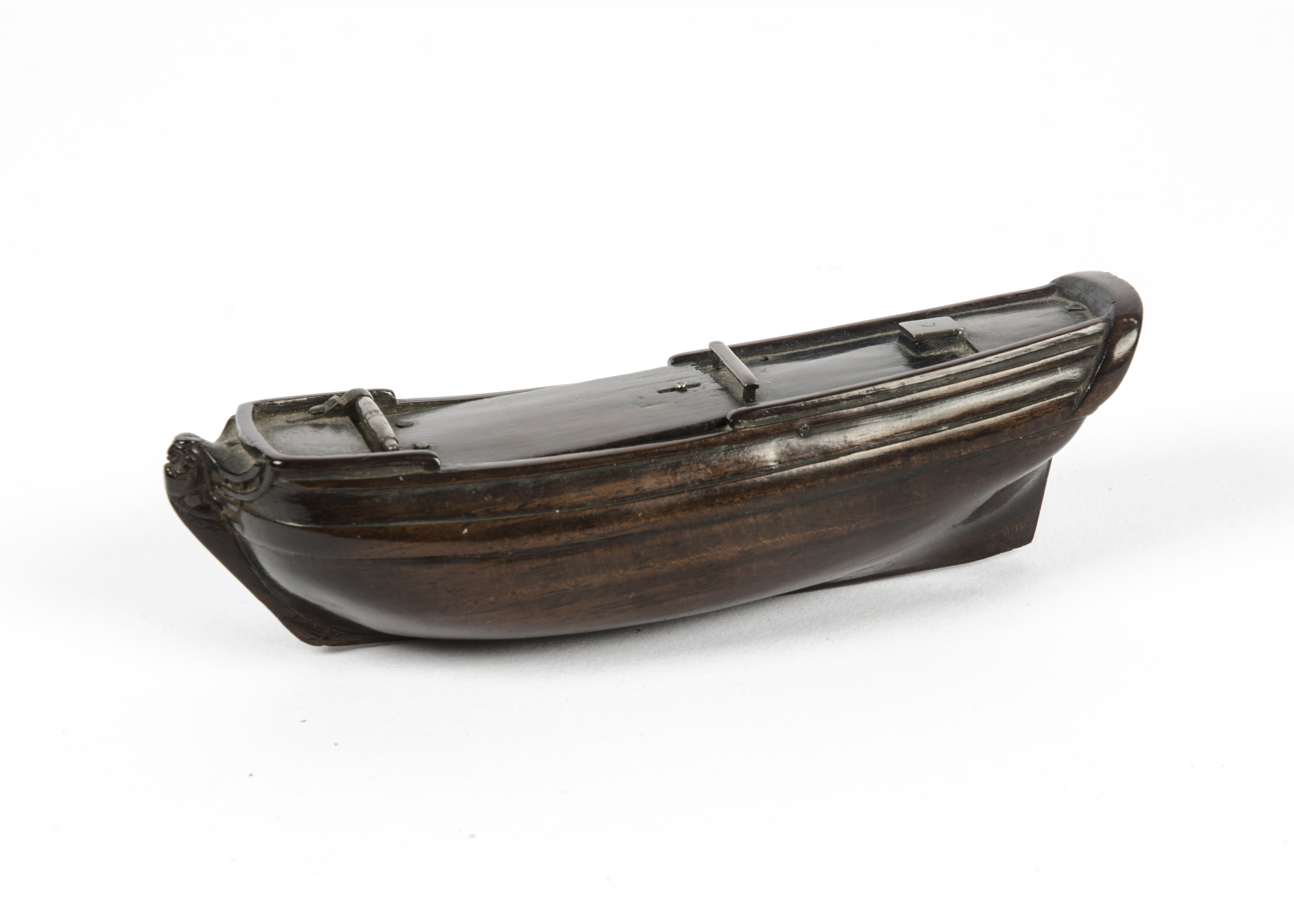 A 19th Century rosewood box taking the form of a boat's hull with several hidden compartments,