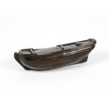 A 19th Century rosewood box taking the form of a boat's hull with several hidden compartments,