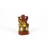 A Chinese soapstone figure of an emperor, he is sitting on a throne with entwined dragons head