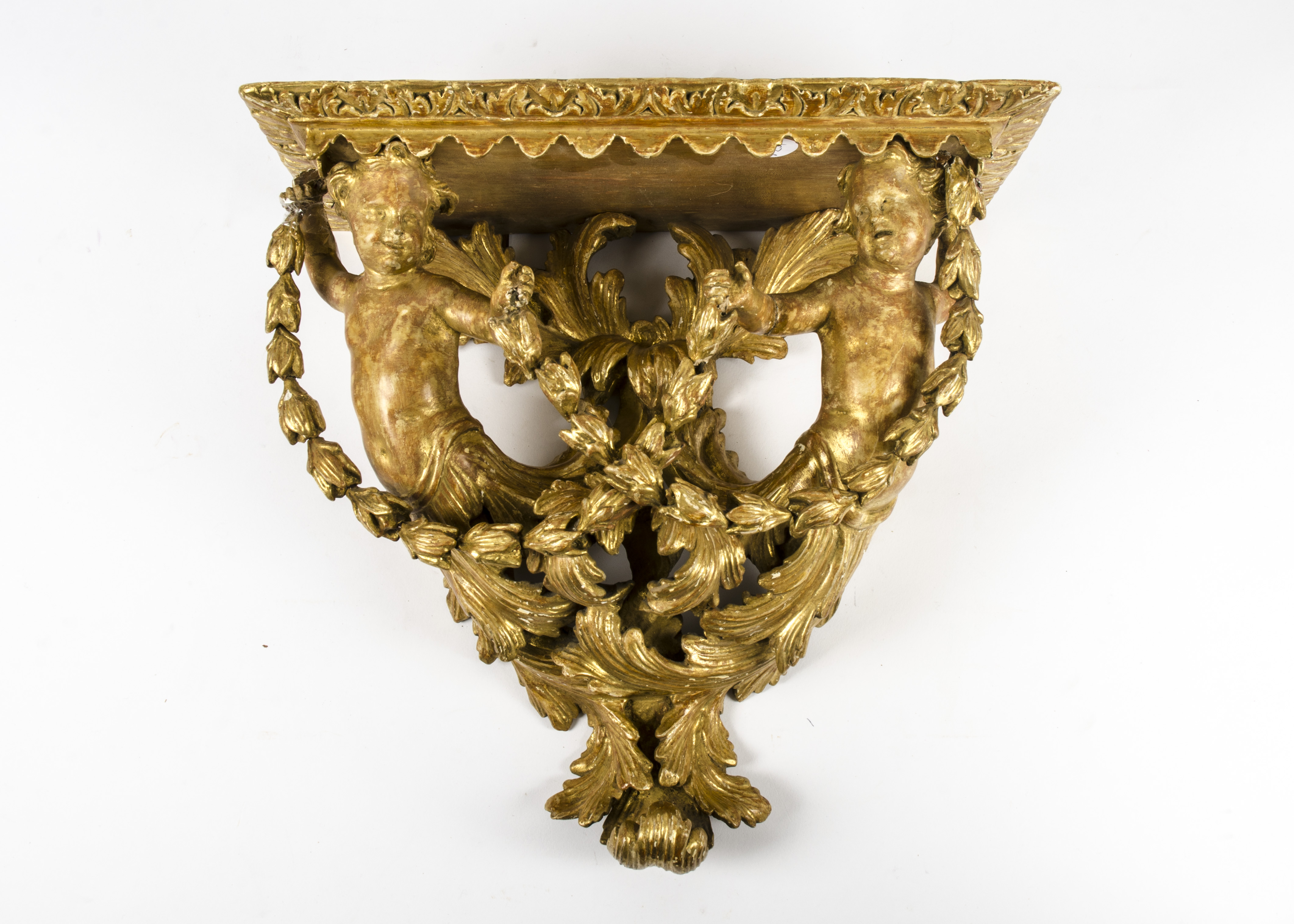 A gilt gesso carved wooden wall bracket, taking the form of two outstretched putti holding
