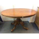 A Victorian Mahogany loo table, plain oval top with a turned bulbous column raised on a carved