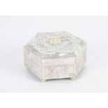 A mother of pearl hexagonal box, with red lining on six globular feet, height 6cm, diameter 12cm